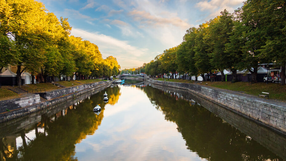 Aura River, blue sky and trees along the river, sky reflects to the water.