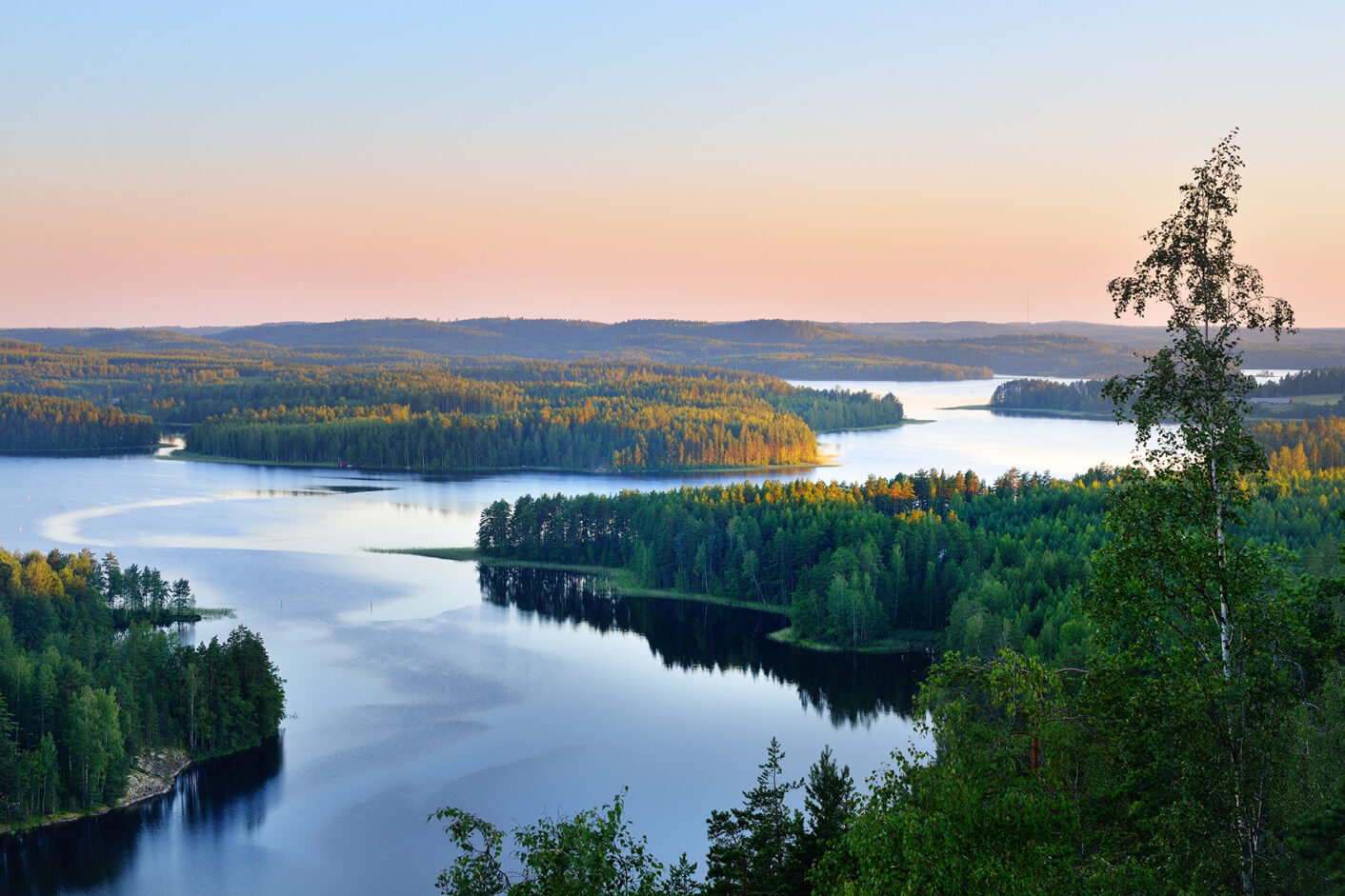 A lakeview with forested islands.